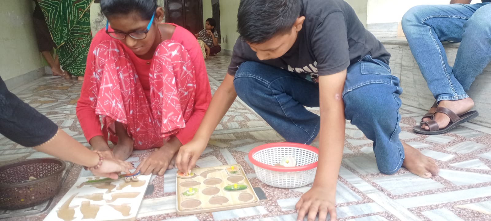 Two children working on a learning board